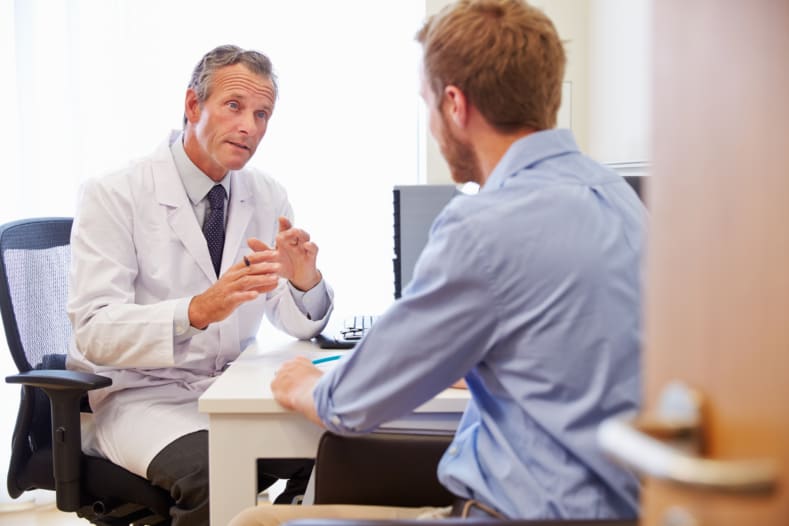 Male Patient Having Consultation With Doctor