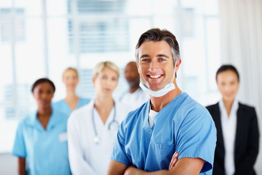 Male Doctor Smiling with Colleagues